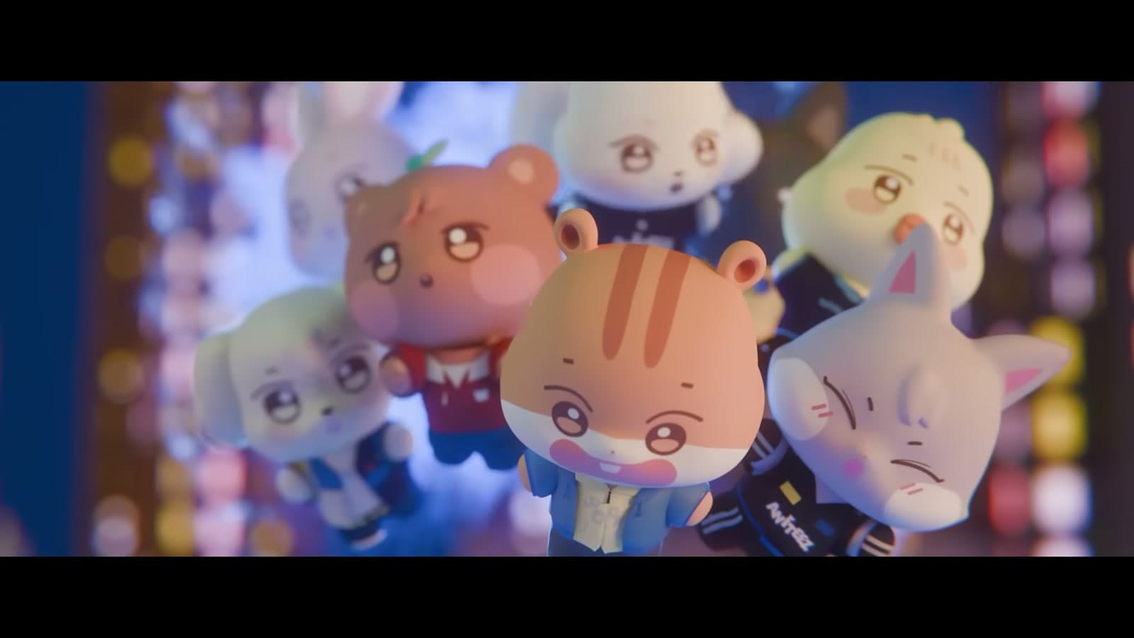 Eight ANITEEZ characters lean forward together in a colourful room, with an orange striped character and a white cat in front.
